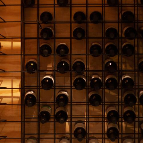 a wall of wine bottles in a wine cellar at Huli B&B in Mendoza