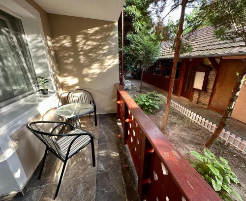 a patio with a table and chairs on a balcony at Kruna Palića in Palić