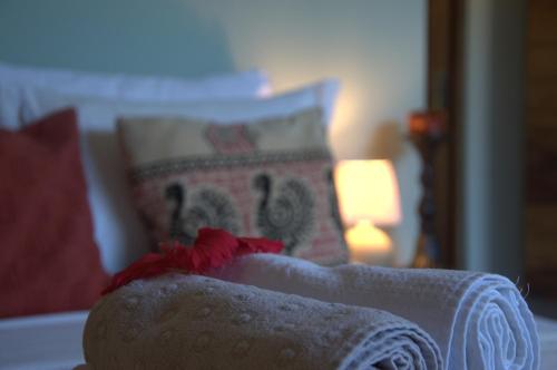 a bedroom with a bed with a blanket and a lamp at Chill Mango in Paracuru