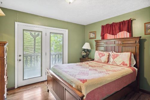 a bedroom with a bed and a window at Mountain Chalet with hot tub ! in Gatlinburg