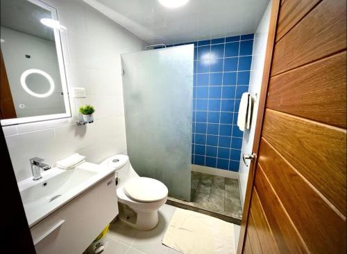 a bathroom with a toilet and a sink and a shower at Beautiful Two bedrooms apartment in Punta Cana