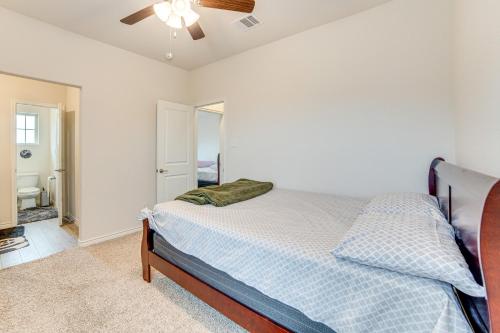 a bedroom with a bed and a ceiling fan at Walk to Lake Ray Hubbard Spacious Family Home! in Forney
