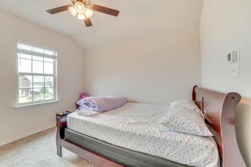 a bedroom with a bed and a ceiling fan at Walk to Lake Ray Hubbard Spacious Family Home! in Forney