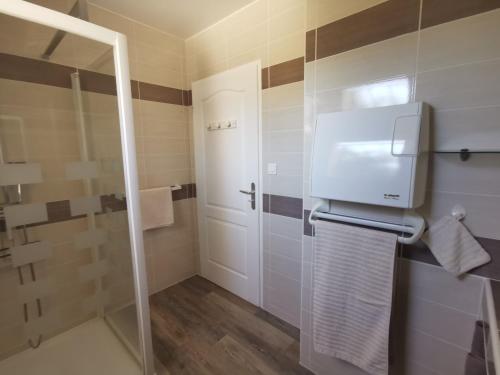 une salle de bain avec douche et porte vitrée dans l'établissement villa near ocean with swimming pool, à Bias