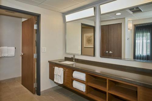 a bathroom with a sink and a mirror at Courtyard Wausau in Wausau