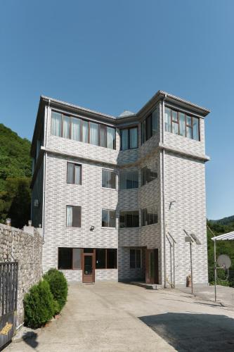 a large brick building with a stone wall at Mtirala Panorama in Khala