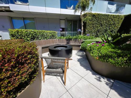 a bench sitting in front of a building with plants at Brand New 1BR Pool & Jacuzzi Free Parking Suite One in Gibraltar