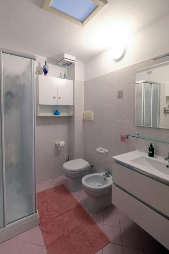 a bathroom with a toilet and a sink and a shower at Casa della Maria in Viareggio