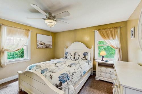 a bedroom with a bed and a ceiling fan at Winthrop Cottage in Oak Bluffs