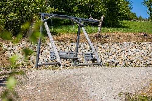 a swing set sitting on top of a pile of rocks at Antkowe Wzgórze in Polańczyk