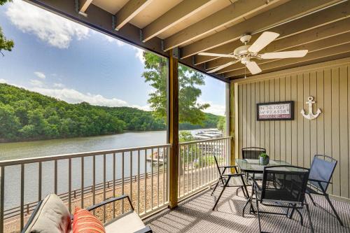 a balcony with a table and chairs and a view of a river at Lake and Pool Access Lazy Days Condo with Balcony! in Osage Beach