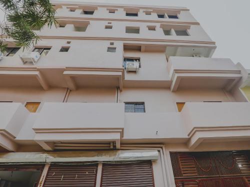 an external view of a building with white balconies at Hotel Navya Grand in Patna
