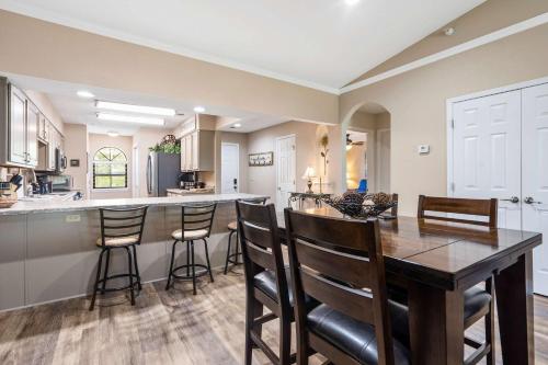 a kitchen and dining room with a table and chairs at Cozy Comfort Retreat - For 6 in Branson