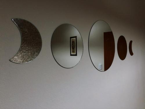 a wall with three mirrors on a wall at Hotel Valle Colorado in Villa Unión