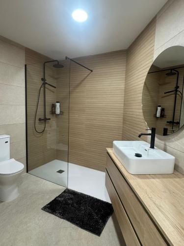 a bathroom with a shower and a sink and a toilet at Villa Atlantic Breeze in Antigua