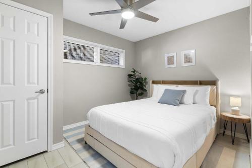 a bedroom with a white bed and a ceiling fan at Stillwater Retreat - For 6 in Kimberling City