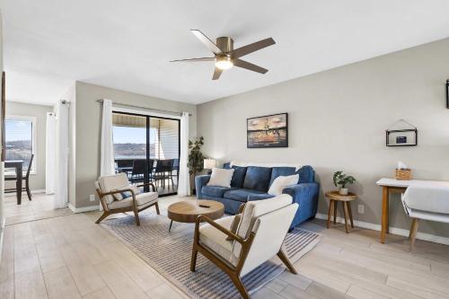 a living room with a blue couch and a table at Stillwater Retreat - For 6 in Kimberling City