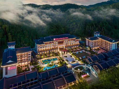 an aerial view of a resort in the mountains at Hilton Garden Inn Zhangjiajie Wulingyuan in Zhangjiajie