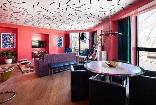 a living room with red walls and a table at Graduate by Hilton New York in New York
