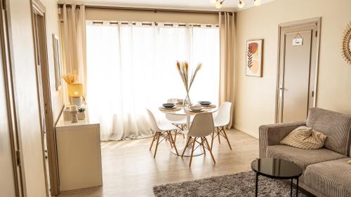 ein Wohnzimmer mit Tisch und Couch in der Unterkunft T2 Cosy centre ville proche gare in Tourcoing
