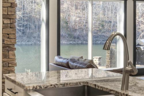 a kitchen with a view of a large window at Foggy River Retreat - For 16 in Hollister