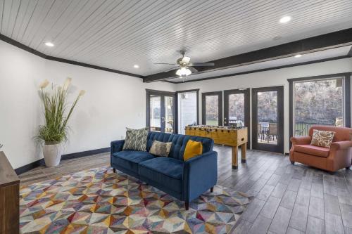 a living room with a blue couch and a table at Foggy River Retreat - For 16 in Hollister