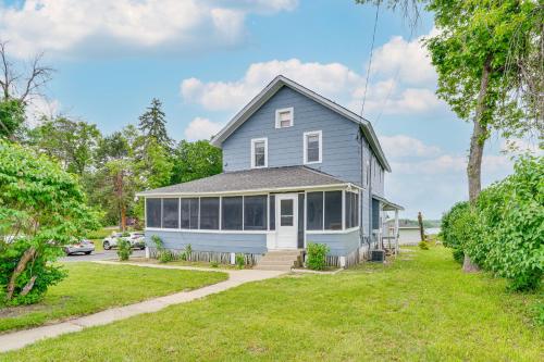 a blue house with a yard at Snowmobile Trail On-Site Waterfront Mound Gem! in Mound