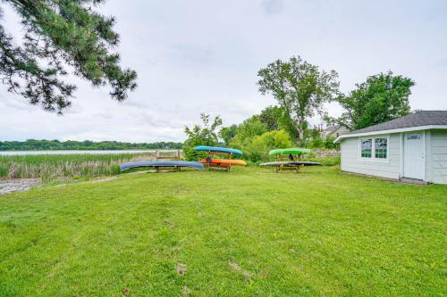 a yard with three picnic tables and a building at Snowmobile Trail On-Site Waterfront Mound Gem! in Mound