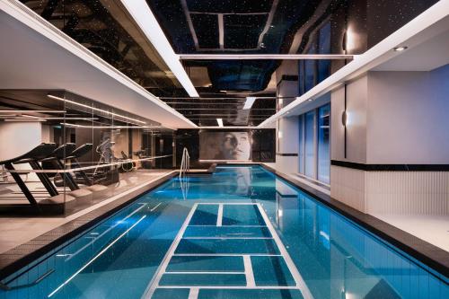 a large swimming pool with blue water in a building at Marsden Viaduct in Auckland