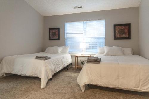two beds sitting next to each other in a bedroom at Mins to Park River Downtown Chapel Hill Charmer in Indianapolis