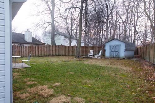 a backyard with a shed and a fence at Mins to Park River Downtown Chapel Hill Charmer in Indianapolis