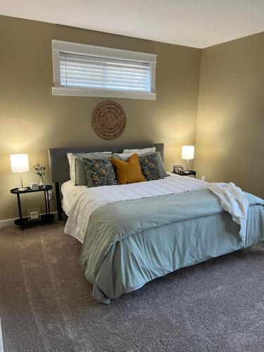 a bedroom with a bed with pillows and a window at Mins to Downtown & Raceway Rookwood Retreat 2 in Indianapolis