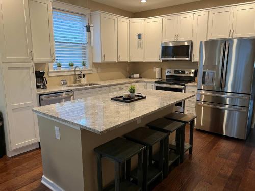 a kitchen with a large island with bar stools at Mins to Downtown & Raceway Rookwood Retreat 2 in Indianapolis