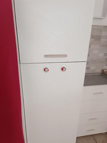 a white chest of drawers in a kitchen at Locazione Turistica in Tessera
