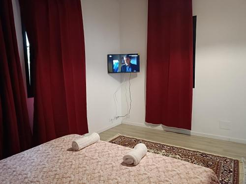 a room with a bed and a tv on a wall at Locazione Turistica in Tessera