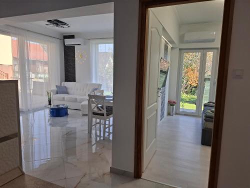 a living room with a white couch and a table at Sweethome12 in Fonyód