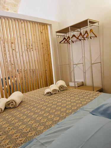a bedroom with a bed with towels on it at Relais Macramè in Manfredonia