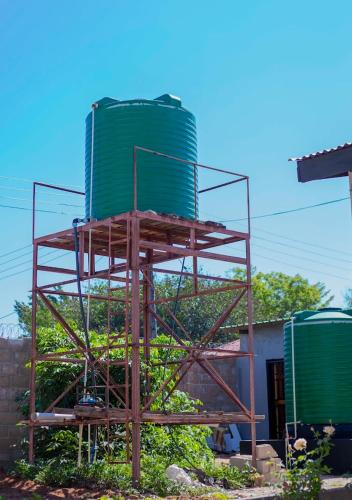 a tower being constructed in front of a building at Magodi Place - Serviced & Airconditioned Apartment in Livingstone