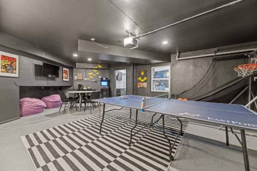 a living room with a ping pong table in it at Dome Manor 2 Game Rooms, Hot Tub & Pool! in Bedford