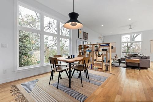 a living room with a dining room table and chairs at Modern Amenities Downtown - Raleigh Craftsman in Raleigh