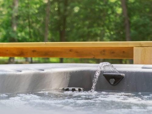 a bird bath with water coming out of it at Dirt Merchant Chalet Trail Access Hot Tub on Back 40 Trail in Bella Vista