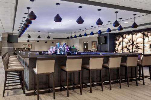 a bar in a restaurant with chairs and lights at Delta Hotels by Marriott Somerset in Somerset