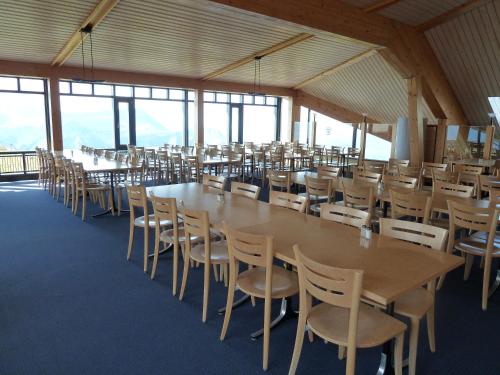 a large dining room with tables and chairs at Berghaus Männlichen in Grindelwald
