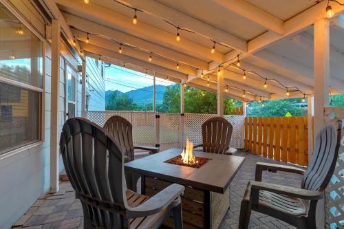 a patio with a table and chairs with a fire place at Vermijo Nook Walk to OCC Downtown w Fire Pit in Colorado Springs