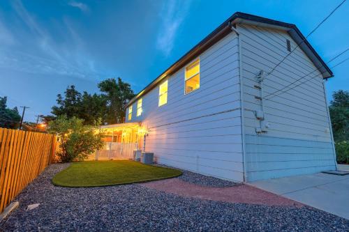 a house with white siding and a fence at Vermijo Flat Walk to Downtown Shops & Dining in Colorado Springs