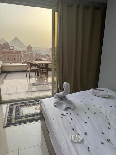 a bedroom with a bed and a view of a balcony at home in the pyramids in Cairo