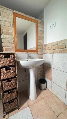 a bathroom with a sink and a mirror at Retro Lakefront House With A Dock in Balatonvilágos