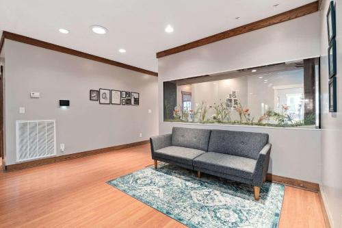 a living room with a couch and a mirror at 5 Minutes to Campbell - Clarksville Craftsman in Clarksville