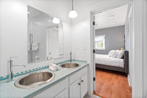 a bathroom with two sinks and a bed at 5 Minutes to Campbell - Clarksville Craftsman in Clarksville