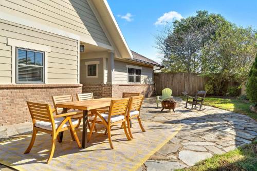 a wooden table and chairs on a patio at 5 Minutes to Campbell - Clarksville Craftsman in Clarksville